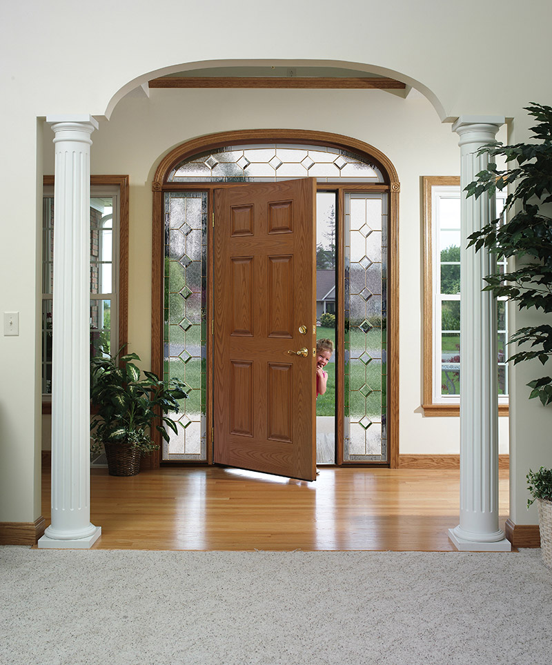 Child opening a Heritage Fiberglass Entry Door