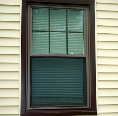 Brown Double-Hung Replacement Window Wrapped In Brown