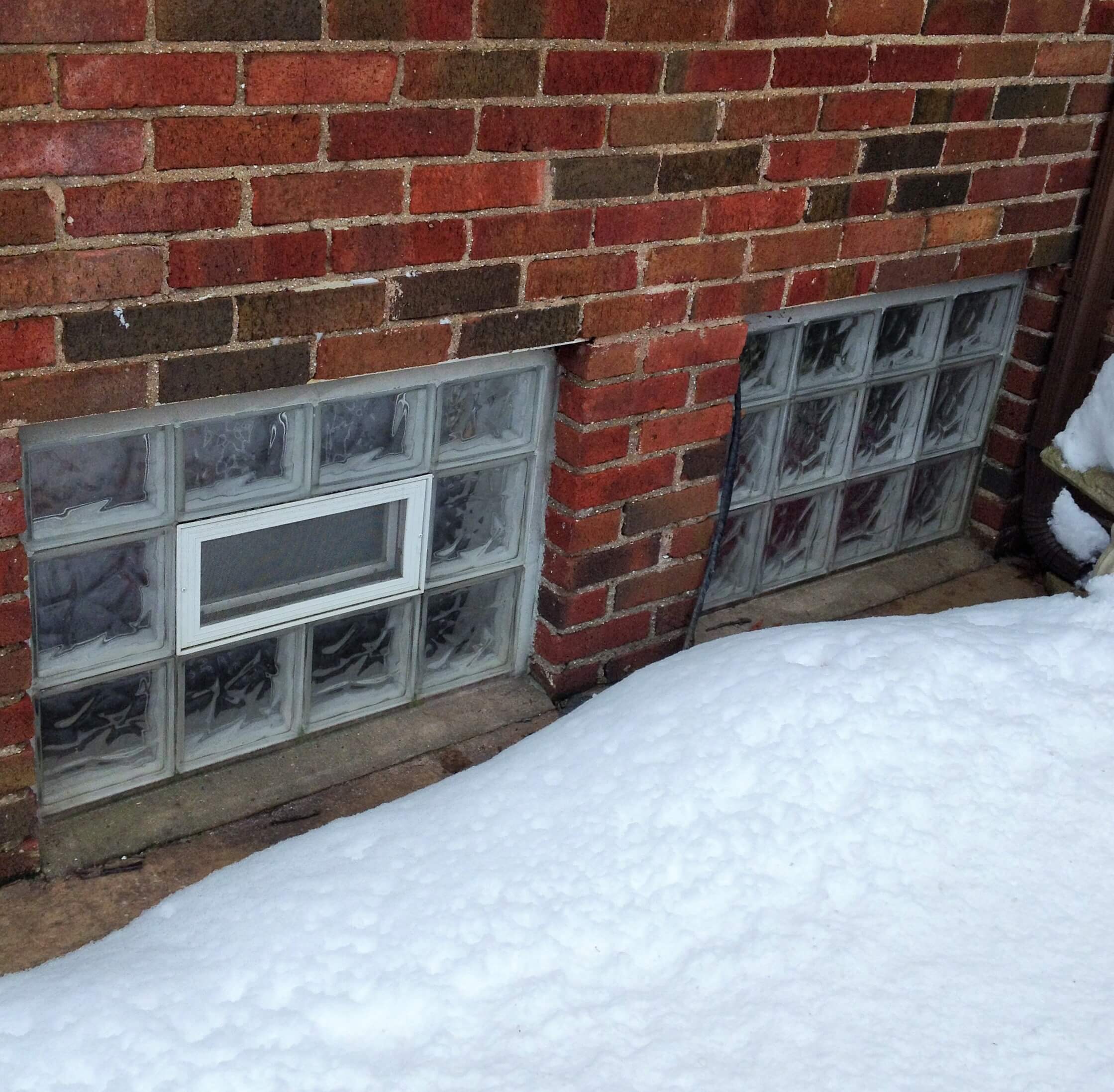 Glass block windows on a brick building in the snow