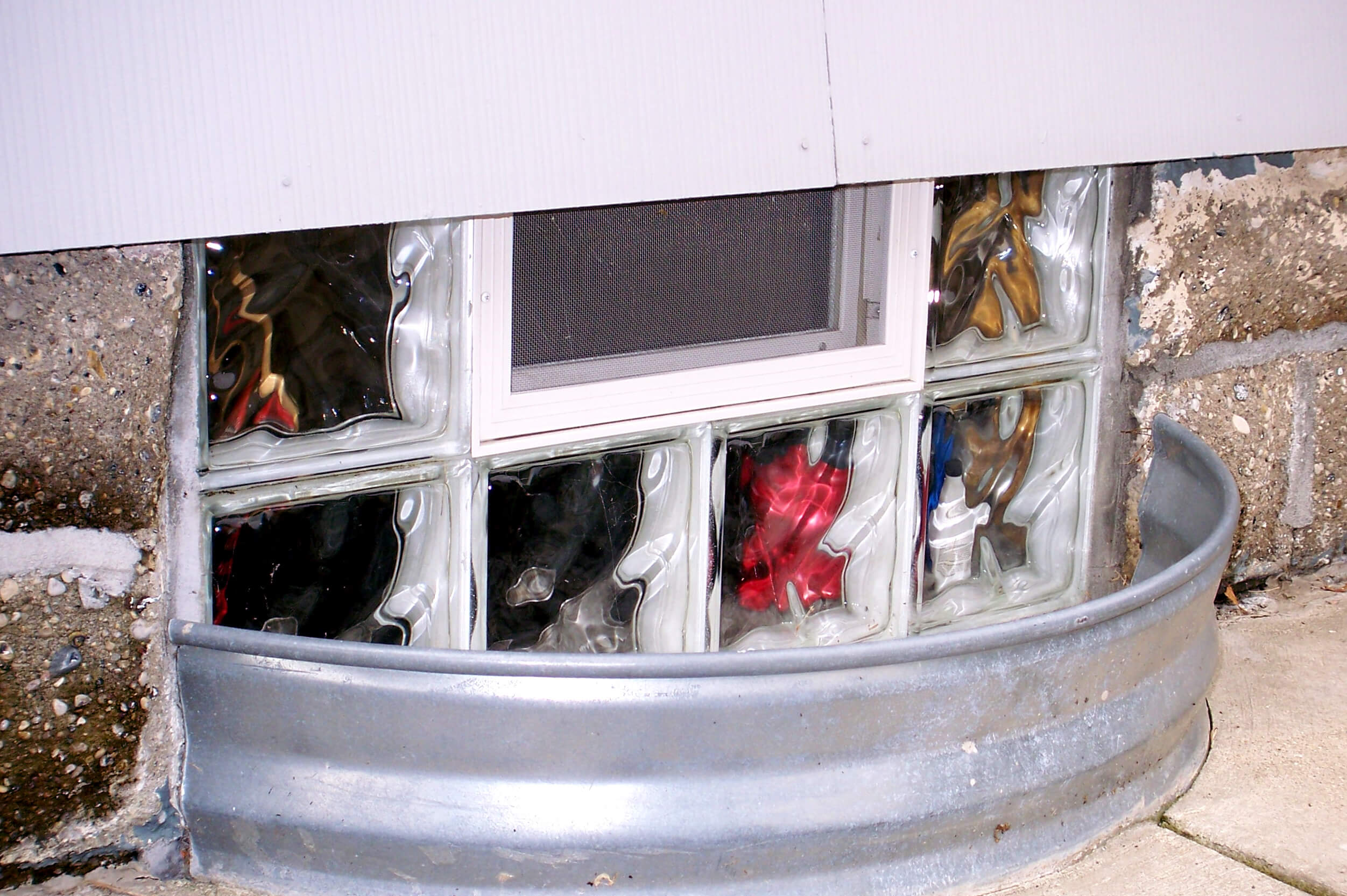 Glass block on shallow window well of house